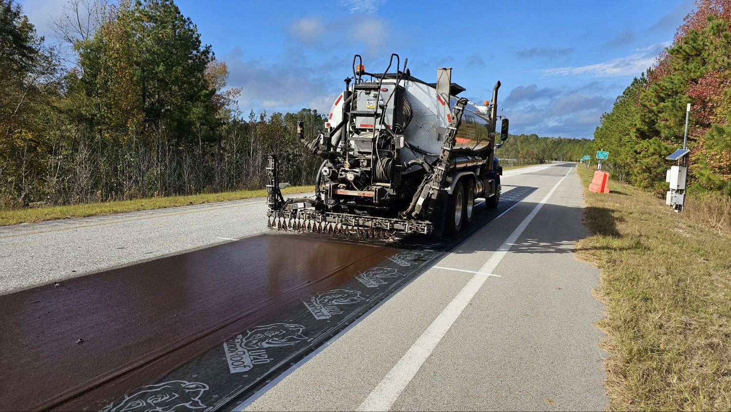 Application of a petroleum-based spray-on rejuvenator at the NCAT Test Track.