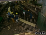 Workers use full-sized pattern to position steel forms for glulam arch