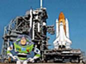 Buzz Lightyear standing in front of a space shuttle on the launch pad